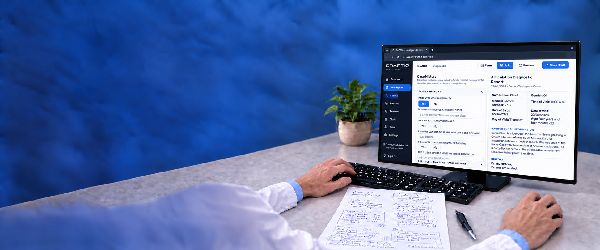 A clinician filling in a new Articulation Diagnostic Report in DraftIQ, with handwritten session notes on the desk beside the keyboard